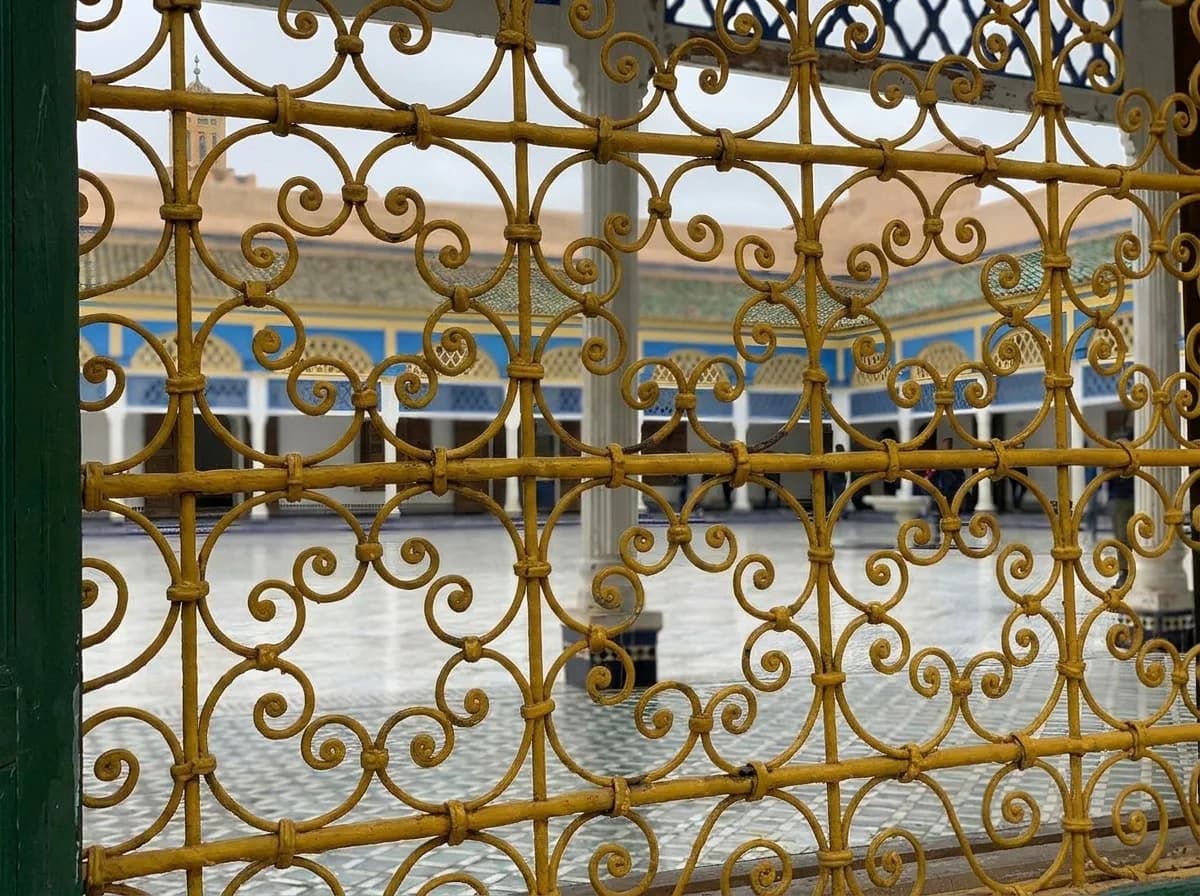 Ornate golden wrought iron window grille looking onto the courtyard at Bahia Palace