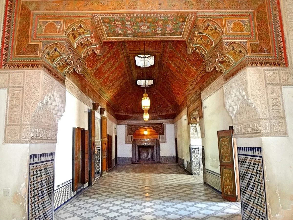Grand salon at Bahia Palace with painted cedar ceiling, hanging lanterns and zellige walls