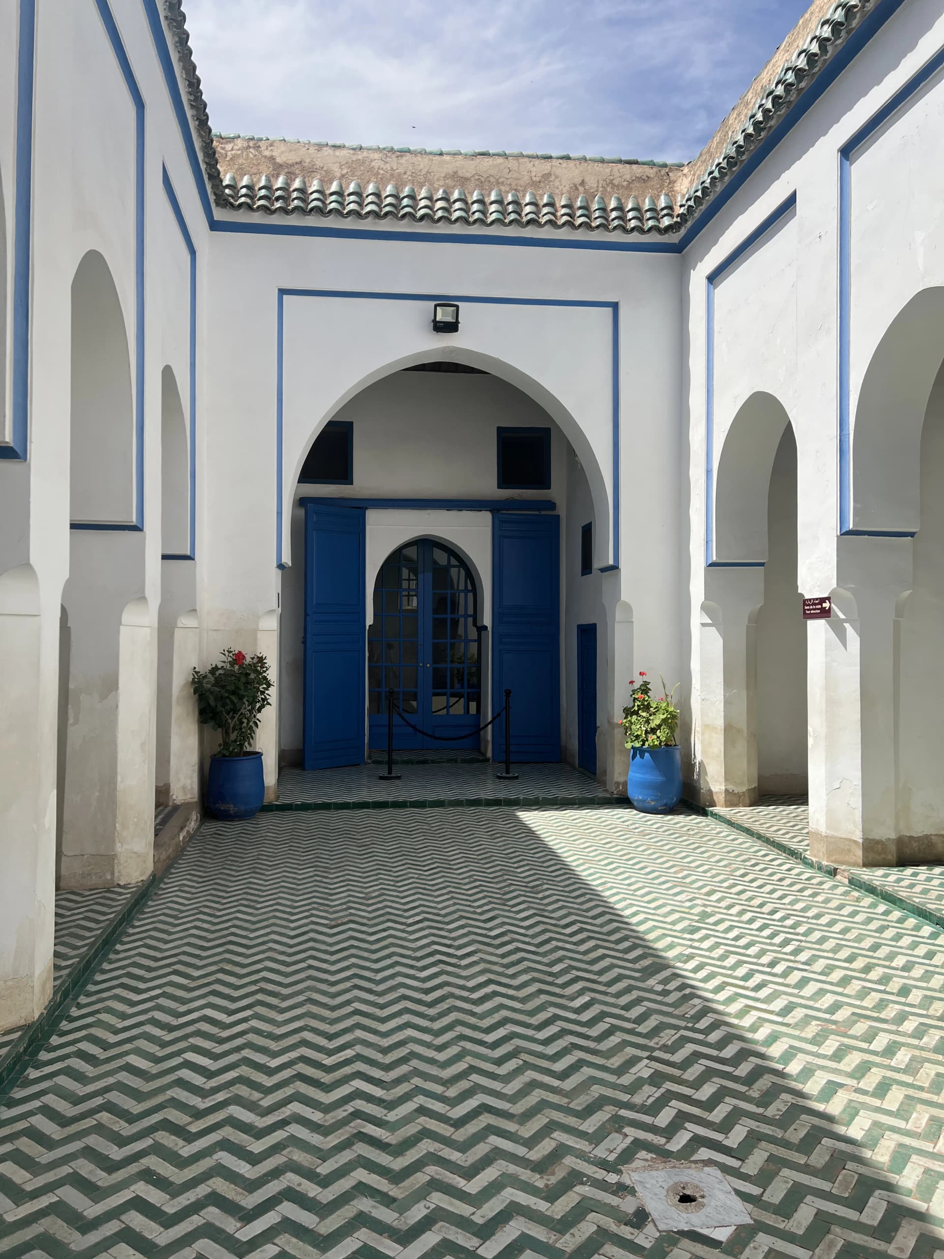 Blue-painted door and zellige-tiled courtyard at Bahia Palace, Marrakech