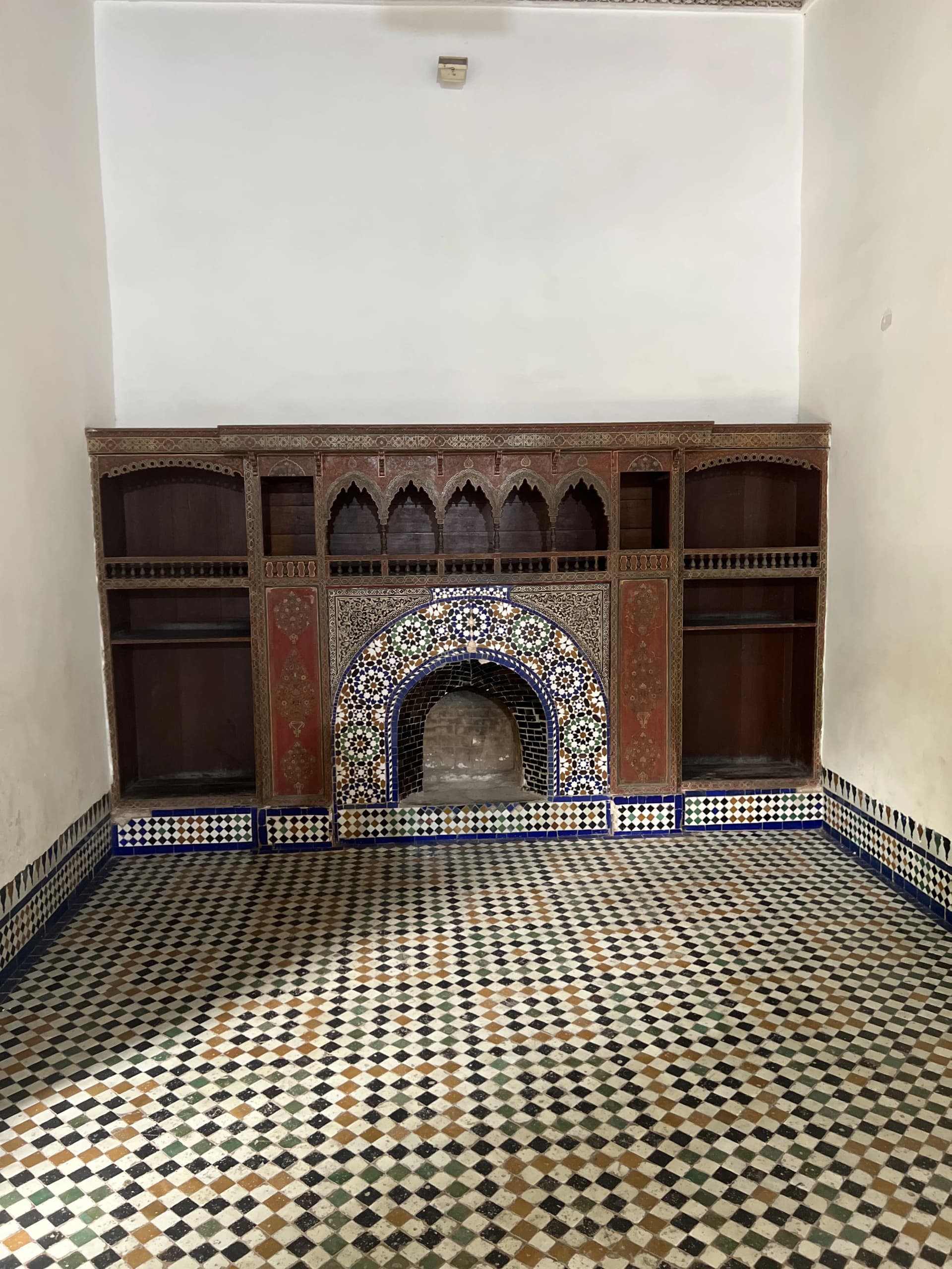 Arched passage with herringbone zellige floor and Moroccan lantern, Bahia Palace