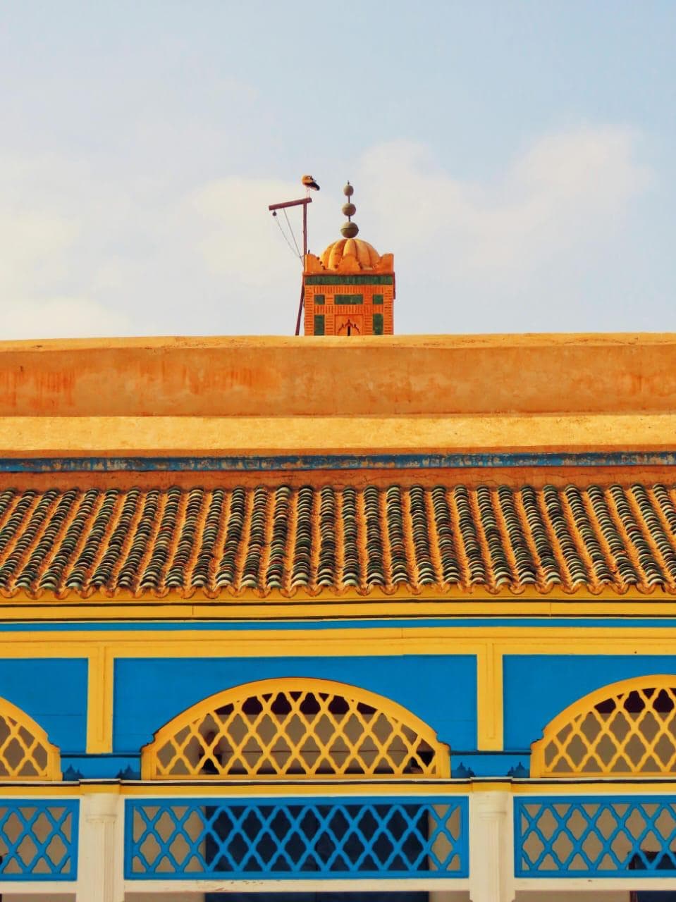 Bahia Palace courtyard with intricate Moroccan tilework, carved cedar wood details, and traditional Andalusian architecture in Marrakech