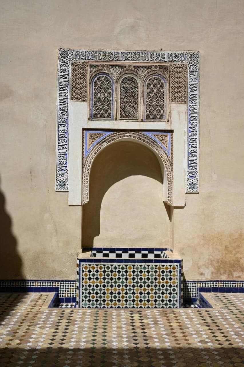 Bahia Palace courtyard with intricate Moroccan tilework, carved cedar wood details, and traditional Andalusian architecture in Marrakech