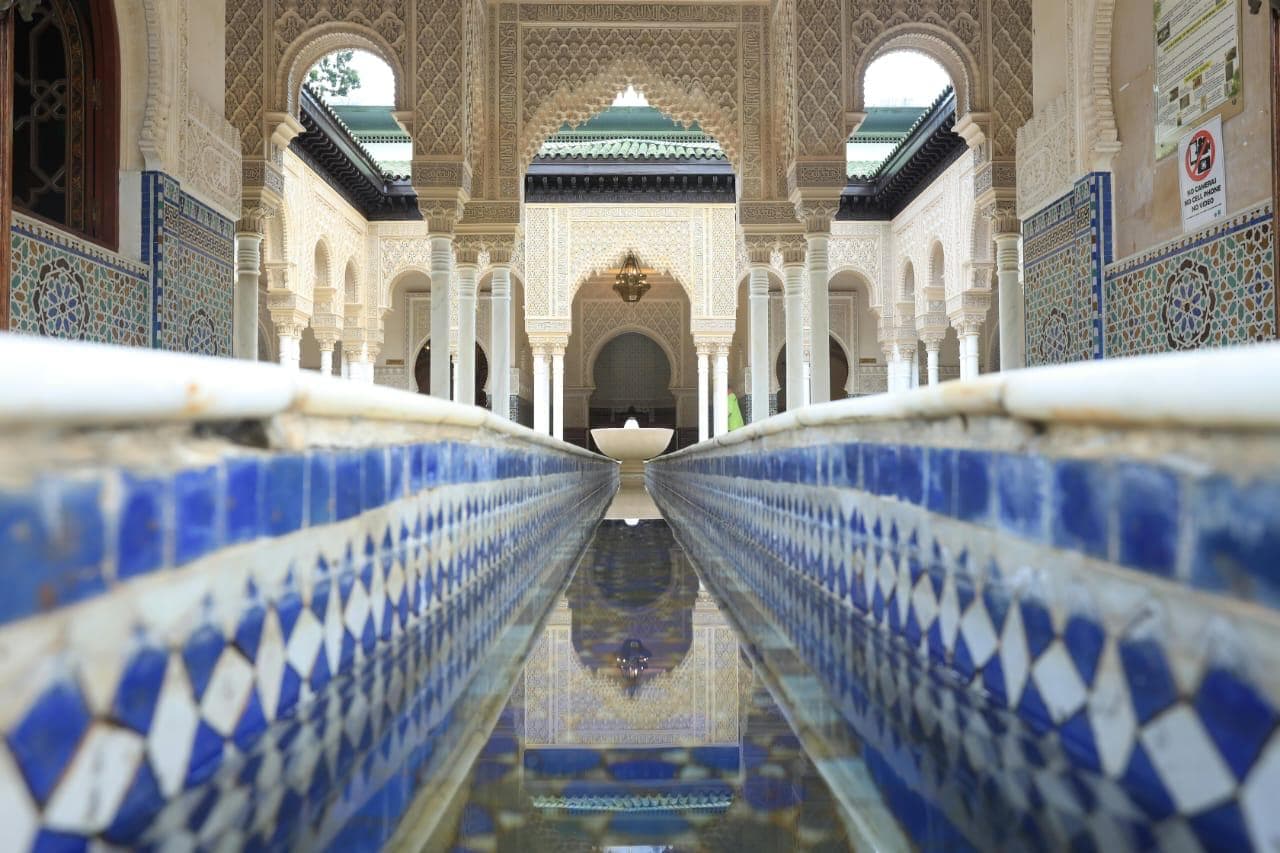 Bahia Palace courtyard with intricate Moroccan tilework, carved cedar wood details, and traditional Andalusian architecture in Marrakech