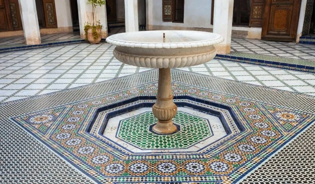Hand-cut zellige mosaic floor in geometric star pattern at Bahia Palace