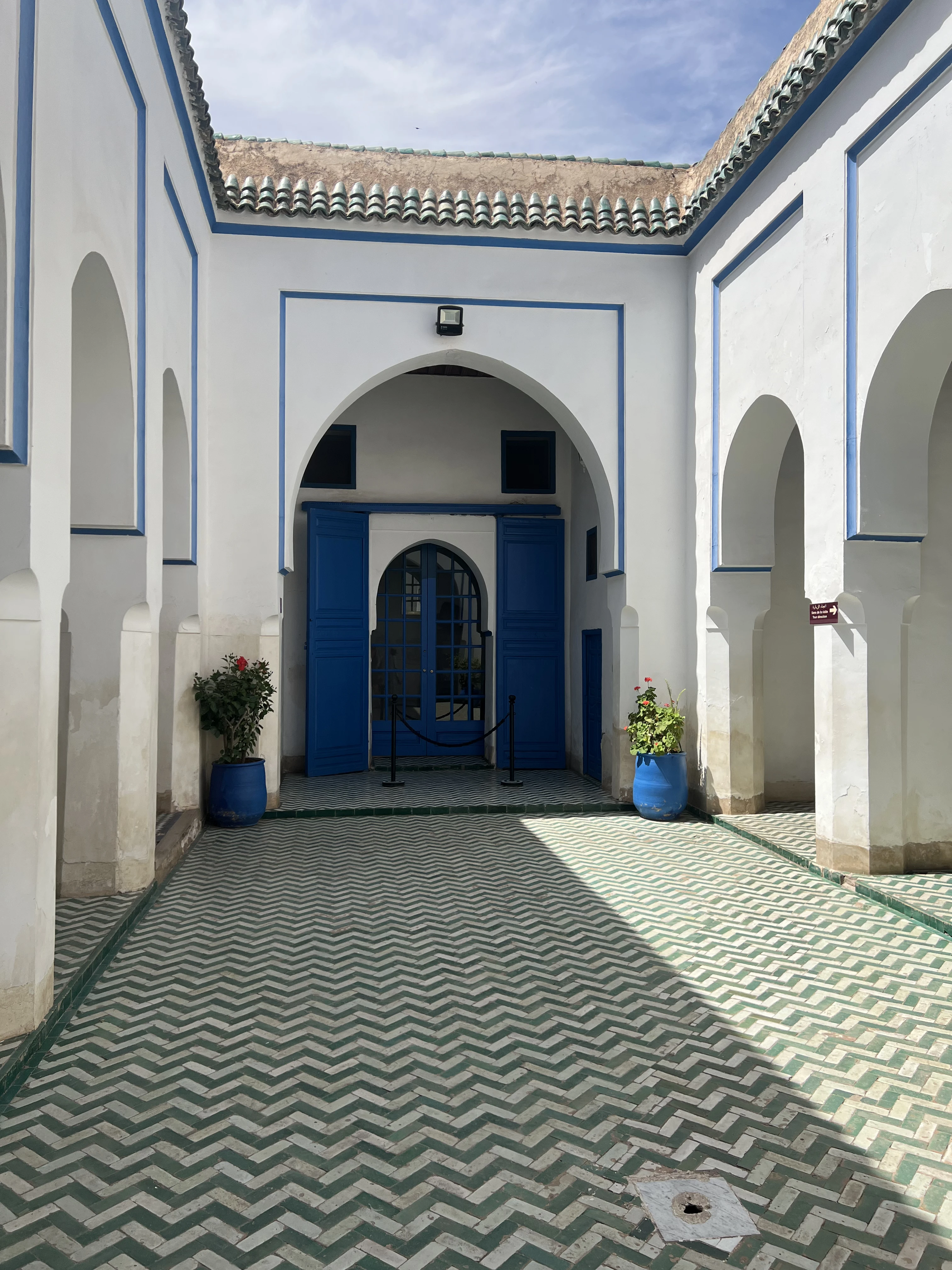 Porte en bois peinte en bleu dans une cour de la médina de Marrakech, typique des entrées de riads dans les quartiers de la Kasbah et du Mellah près du palais Bahia